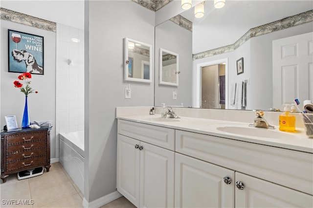 bathroom featuring a relaxing tiled tub, vanity, and tile patterned floors