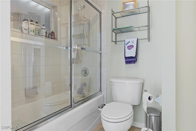 bathroom featuring toilet and enclosed tub / shower combo