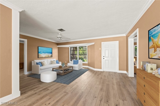 living room with crown molding, ceiling fan, a textured ceiling, and light wood-type flooring