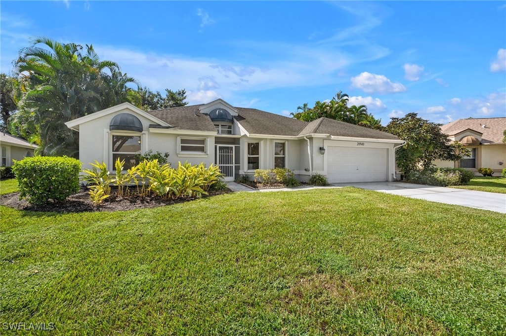 single story home featuring a front yard and a garage