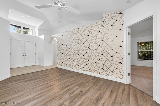 foyer with ceiling fan, lofted ceiling, and hardwood / wood-style floors