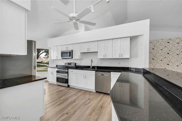 kitchen with light wood-type flooring, ceiling fan, white cabinets, sink, and appliances with stainless steel finishes