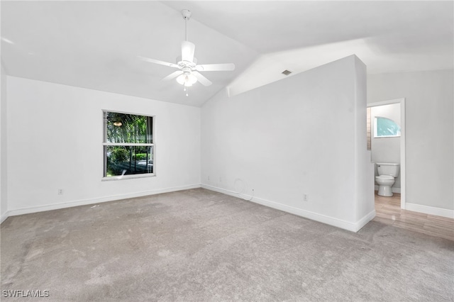 carpeted empty room featuring lofted ceiling and ceiling fan