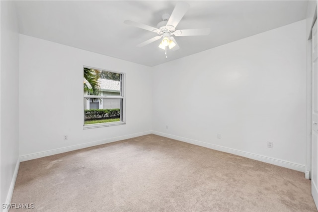 unfurnished room with ceiling fan and light carpet