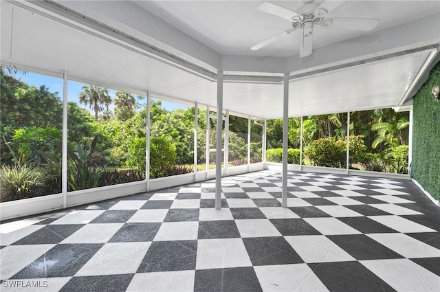 unfurnished sunroom featuring ceiling fan