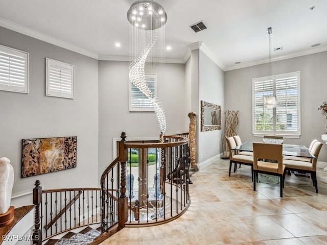 hall featuring ornamental molding, light tile patterned flooring, and a chandelier