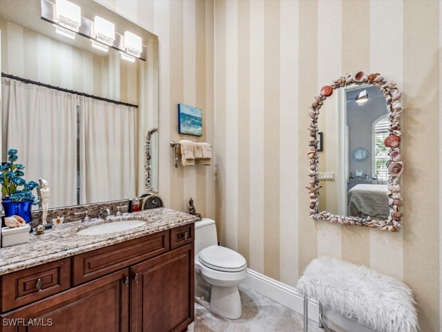 bathroom featuring vanity and toilet