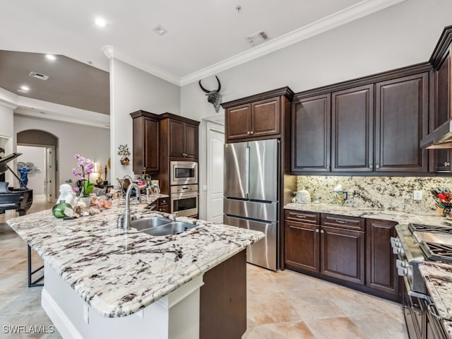 kitchen featuring appliances with stainless steel finishes, sink, a spacious island, a kitchen breakfast bar, and decorative backsplash