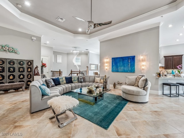 living room featuring a raised ceiling, ornamental molding, and light tile patterned flooring