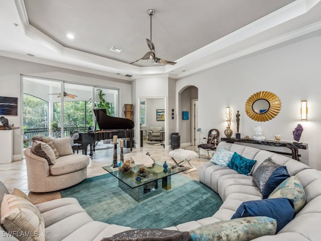 living room with ornamental molding and a tray ceiling