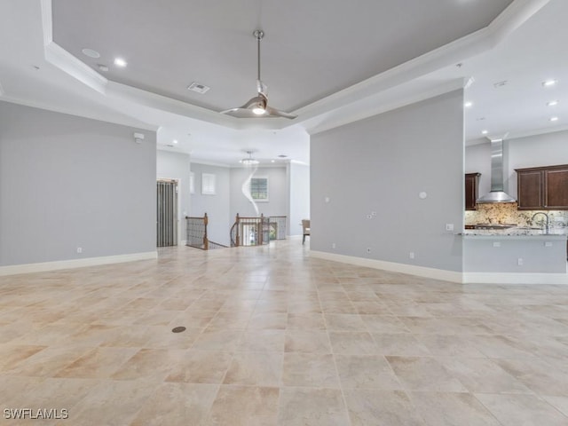 28520 Calabria Ct Unit 201, Naples, FL 34110 - unfurnished living room with crown molding, a raised ceiling, baseboards, visible vents, and ceiling fan
