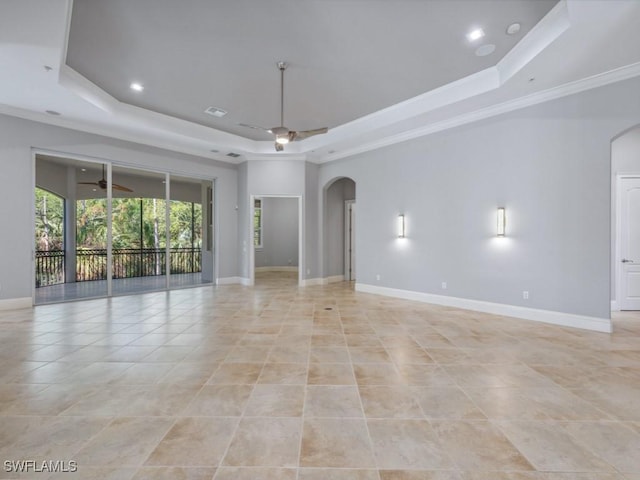 28520 Calabria Ct Unit 201, Naples, FL 34110 - spare room featuring arched walkways, a tray ceiling, baseboards, and a ceiling fan