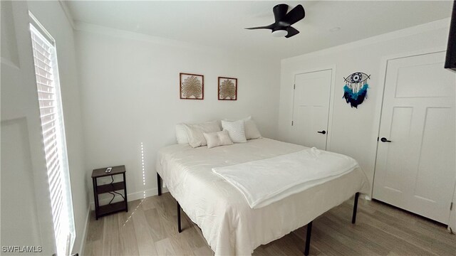 bedroom featuring ornamental molding, hardwood / wood-style floors, and ceiling fan