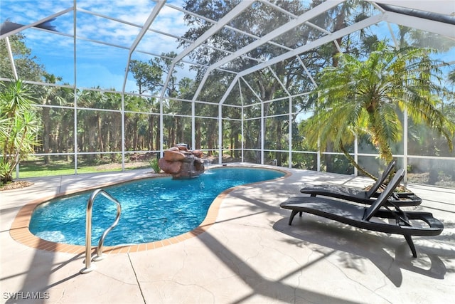 view of pool with a patio area and a lanai