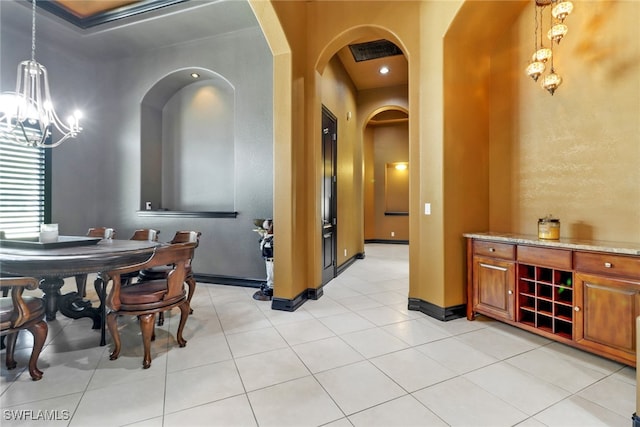 dining room with light tile patterned flooring and an inviting chandelier