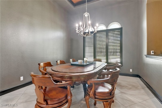 tiled dining room with an inviting chandelier