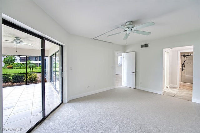 carpeted spare room featuring ceiling fan