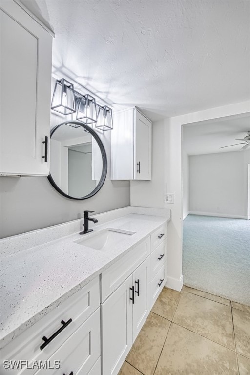 bathroom featuring tile patterned flooring, vanity, and ceiling fan