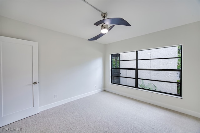 unfurnished room with ceiling fan, plenty of natural light, and carpet