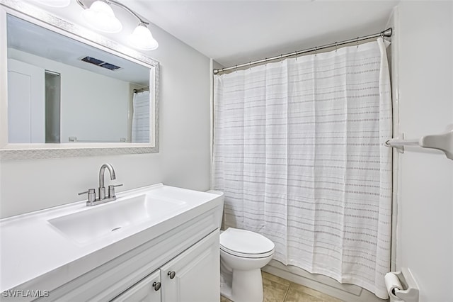 bathroom with tile patterned flooring, walk in shower, vanity, and toilet