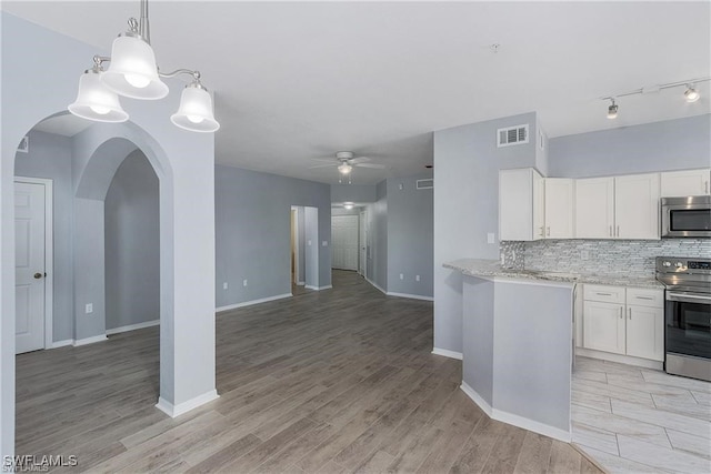 kitchen with appliances with stainless steel finishes, ceiling fan, light hardwood / wood-style flooring, and white cabinets