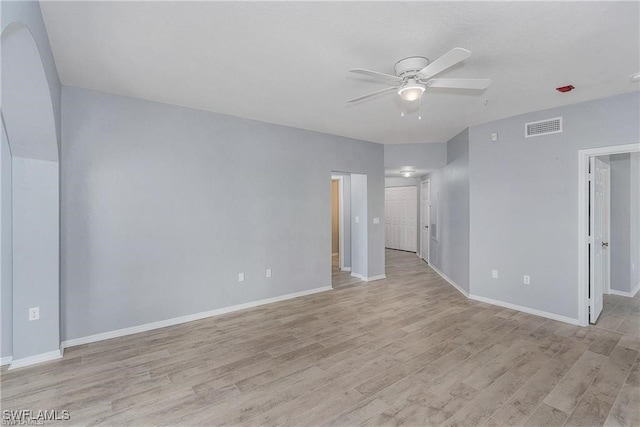 unfurnished room with light wood-type flooring and ceiling fan