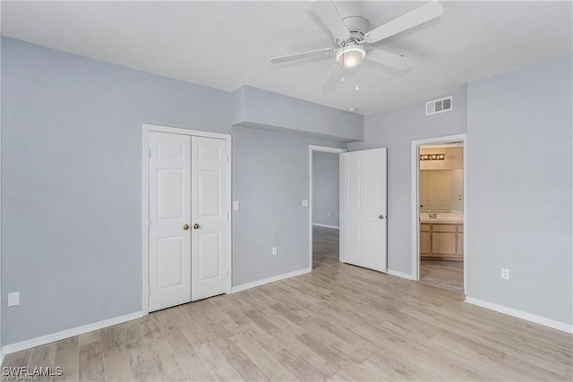 unfurnished bedroom with a closet, light wood-type flooring, and ceiling fan