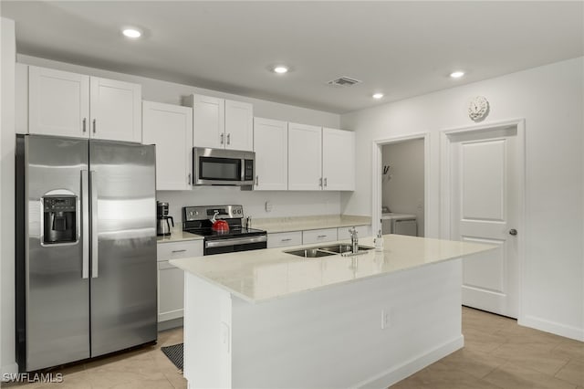 kitchen with a kitchen island with sink, appliances with stainless steel finishes, and white cabinetry