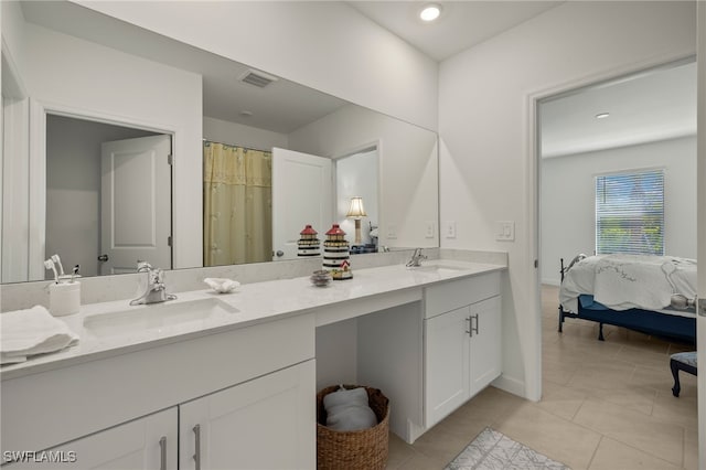 bathroom featuring walk in shower, vanity, and tile patterned flooring