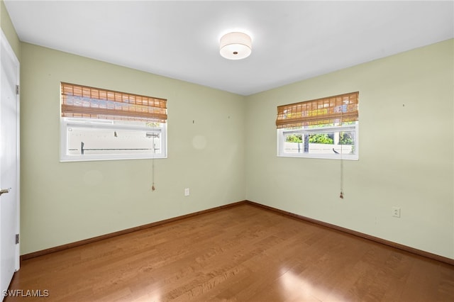1235 Rordon Ave, Naples, FL 34103 - unfurnished room with plenty of natural light, wood finished floors, and baseboards