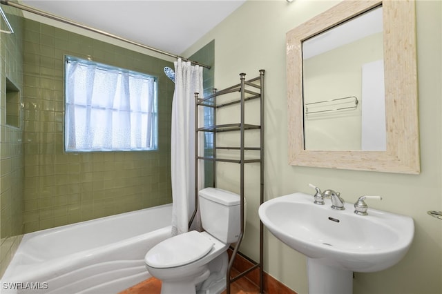 full bathroom featuring sink, toilet, and shower / bath combination with curtain