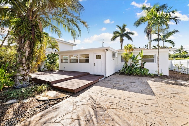 1235 Rordon Ave, Naples, FL 34103 - view of front of house featuring a deck, a patio area, and fence