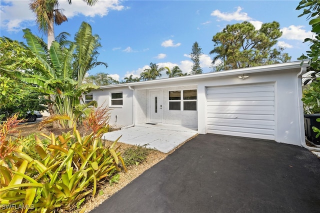 1235 Rordon Ave, Naples, FL 34103 - ranch-style home with stucco siding, a garage, and asphalt driveway