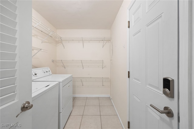 laundry room featuring separate washer and dryer and light tile patterned floors