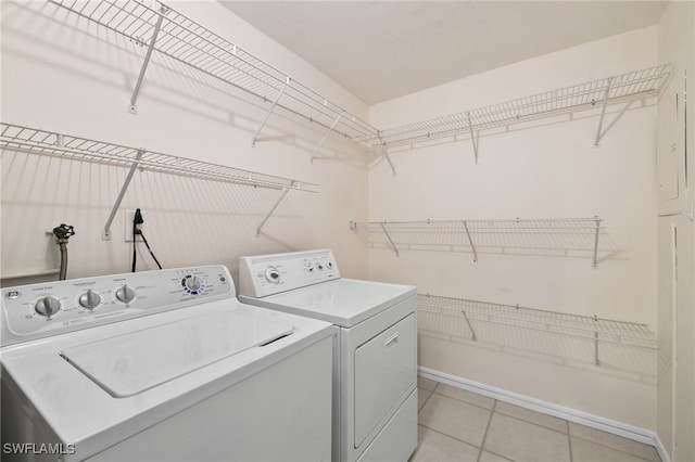 washroom featuring light tile patterned flooring and washing machine and clothes dryer