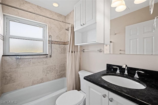 full bathroom with vanity, toilet, and shower / tub combo