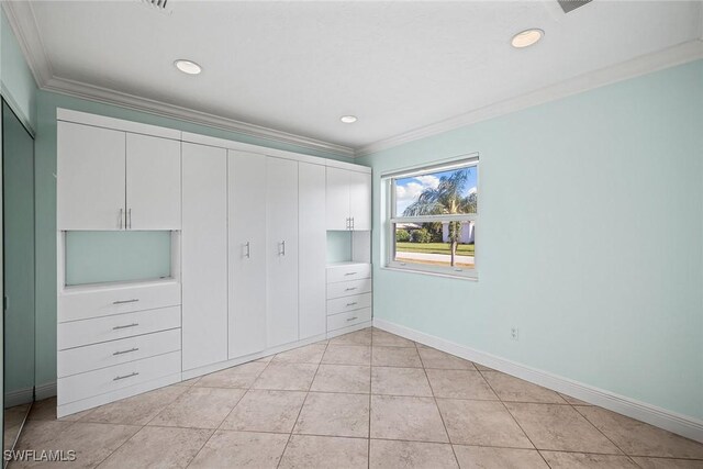 unfurnished bedroom with crown molding and light tile patterned flooring