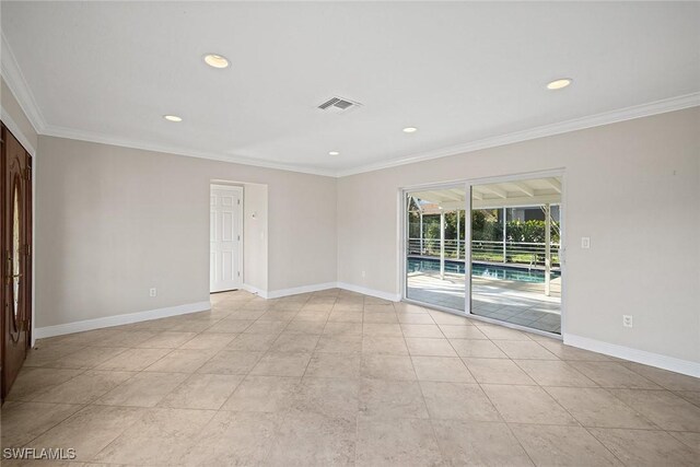 empty room with light tile patterned flooring and crown molding