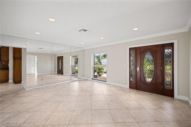 foyer entrance featuring ornamental molding and light tile patterned floors