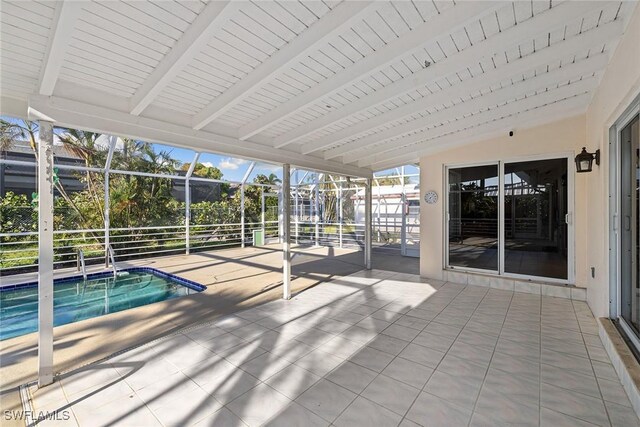 unfurnished sunroom featuring vaulted ceiling with beams and a pool