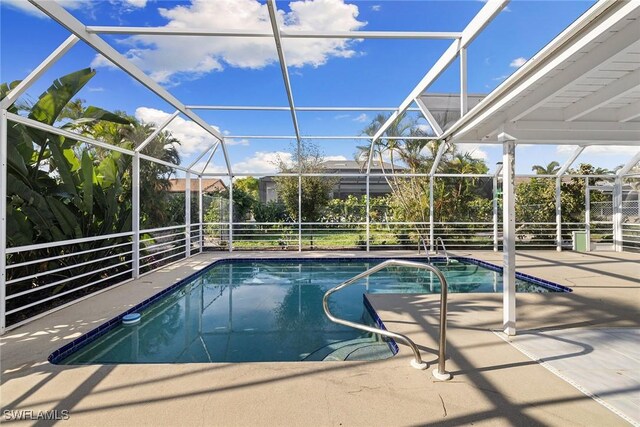 view of swimming pool with a patio and a lanai