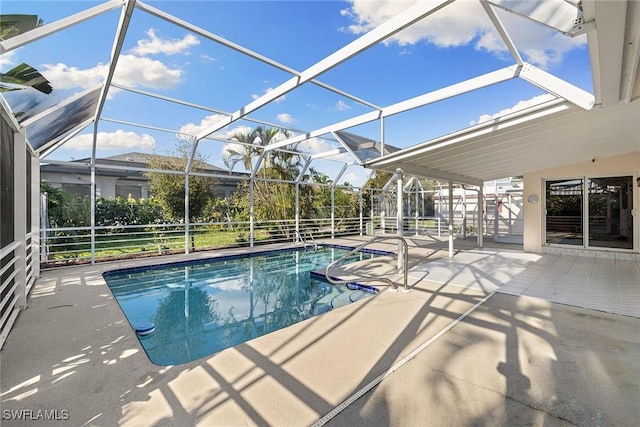 view of pool featuring glass enclosure and a patio