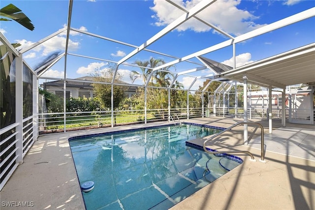 view of swimming pool with glass enclosure and a patio