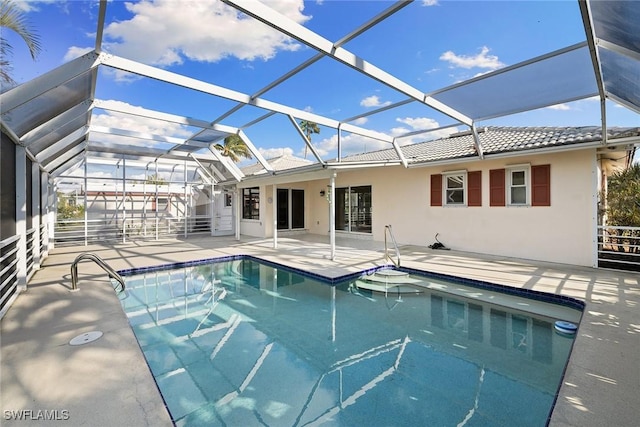 view of swimming pool featuring glass enclosure and a patio area