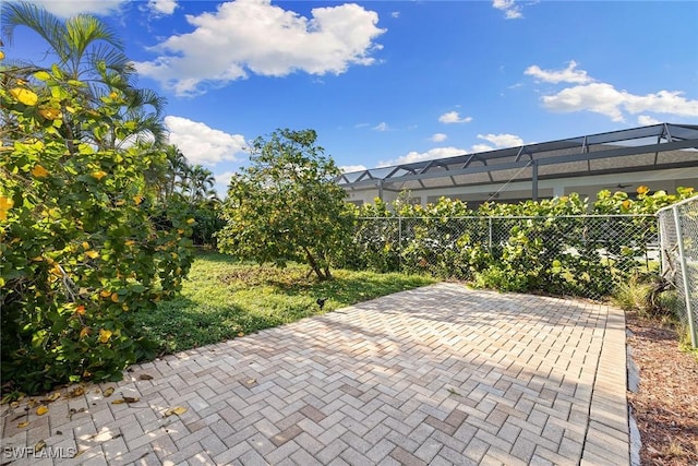 view of patio with glass enclosure