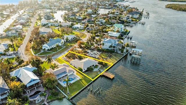 drone / aerial view with a water view and a residential view