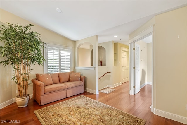 living room featuring vaulted ceiling and hardwood / wood-style floors