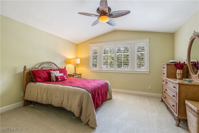 carpeted bedroom with ceiling fan and vaulted ceiling