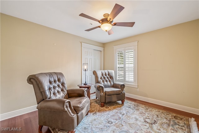 sitting room featuring hardwood / wood-style flooring and ceiling fan