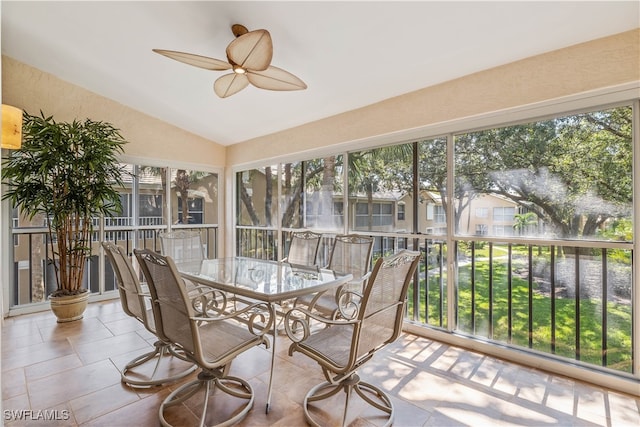 sunroom / solarium featuring lofted ceiling, plenty of natural light, and ceiling fan